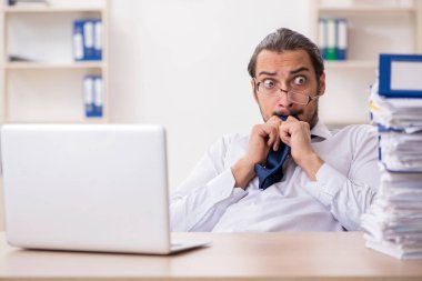 Genç işadamı ofisteki aşırı işten memnun değil.