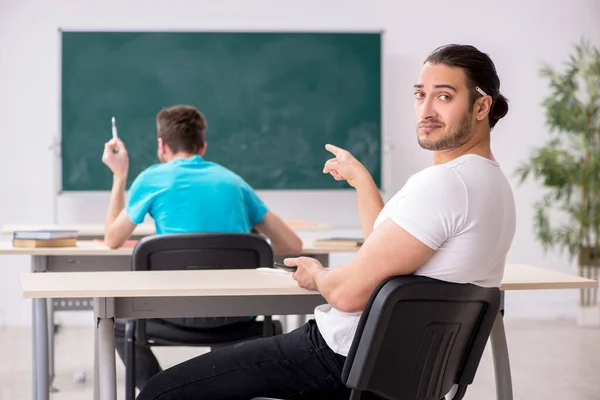 Twee mannelijke leerlingen in het pestconcept in de klas — Stockfoto