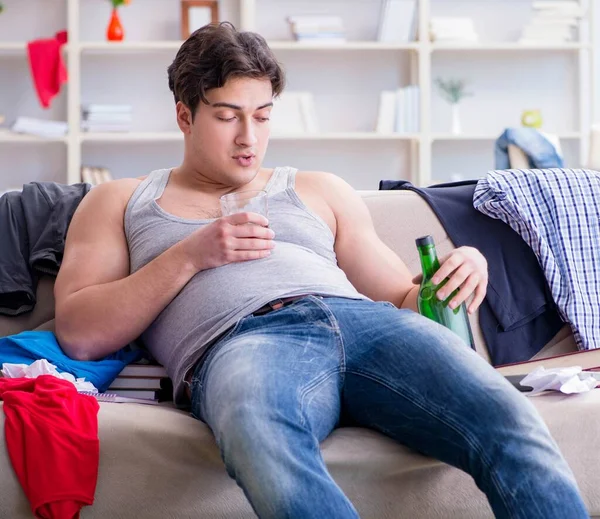 汚い部屋で若い男学生飲酒アルコール — ストック写真