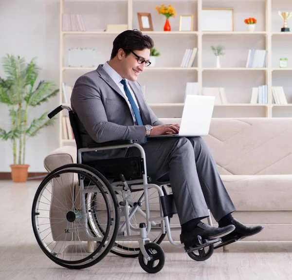 Dsabled businessman on wheelchair working home — Stock Photo, Image