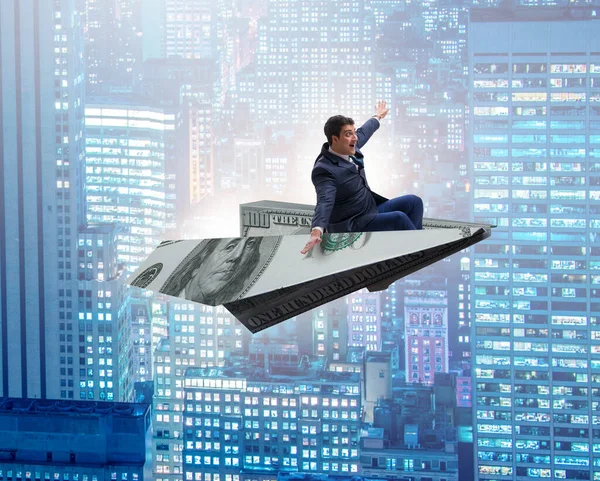 Uomo d'affari che vola su un aereo di carta nel concetto di business — Foto Stock