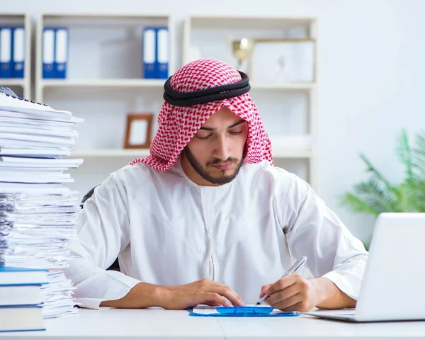 Arab businessman working in the office doing paperwork with a pi — Stock Photo, Image