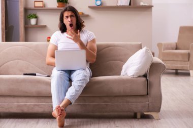 Evde uyuyakalan genç tembel adam