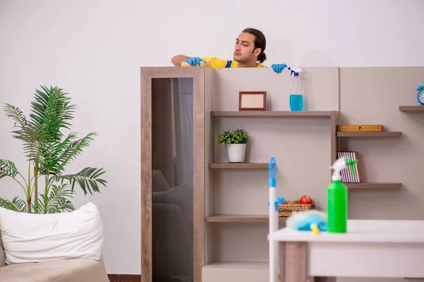 Young male contractor cleaning the house — Stock Photo, Image