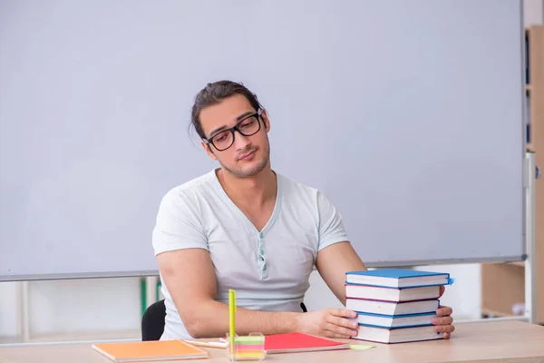 教室に座っている若い男性教師の学生 — ストック写真