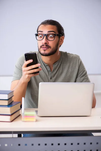 Young male student preparing for exams in the classroom — Stock Photo, Image