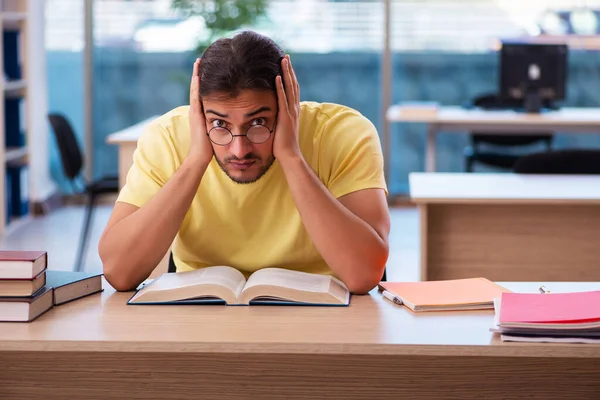 Giovane studente maschio che si prepara per gli esami in classe — Foto Stock