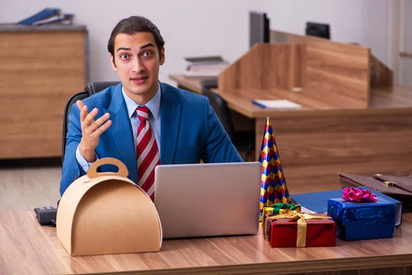 Young male employee celebrating Christmas at workplace — Stock Photo, Image