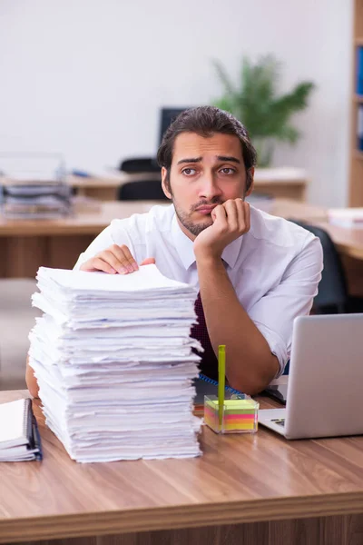 Joven empleado masculino descontento con el trabajo excesivo en la oficina — Foto de Stock