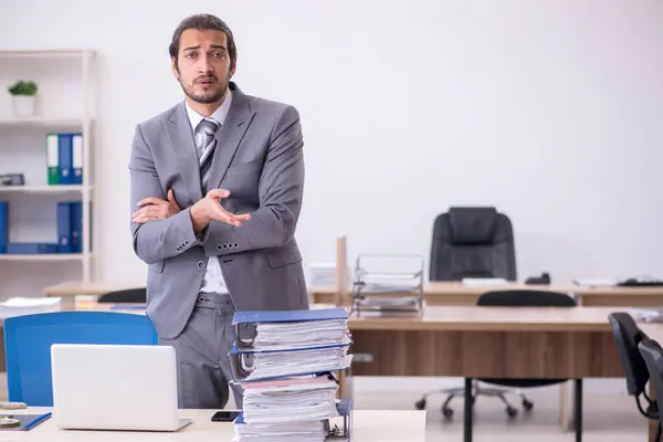 Giovane dipendente maschio infelice con un lavoro eccessivo in ufficio — Foto Stock