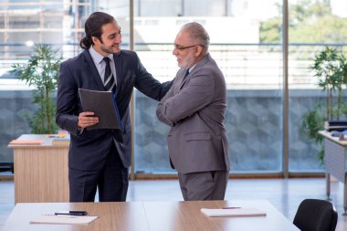 Two businessmen discussing business project clipart