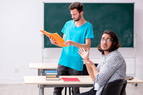 Two male pupils in bullying concept in the classroom — Stock Photo, Image