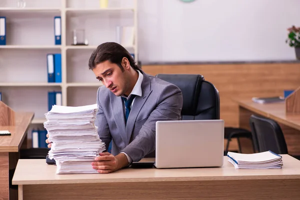 Jeune employé masculin mécontent du travail excessif au bureau — Photo