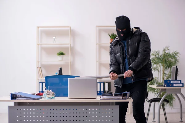 Young male burglar in the office — Stock Photo, Image