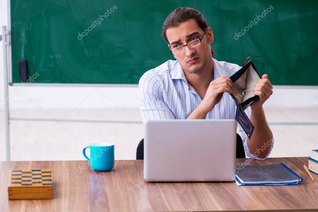 Young male teacher in remuneration concept