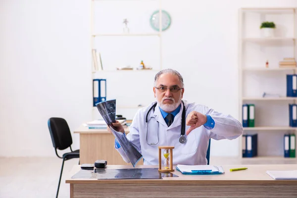 Zaman yönetimi konseptinde yaşlı erkek doktor radyoloji uzmanı. — Stok fotoğraf
