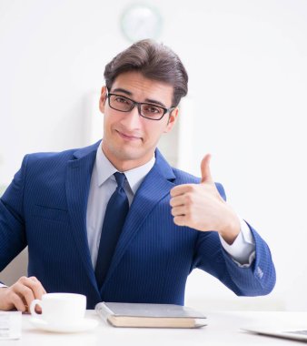 Masada çalışan yakışıklı bir işadamı.