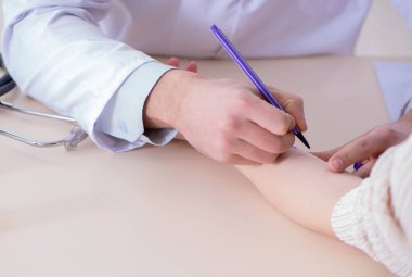 Hastanedeki hastanın alerji reaksiyonunu test eden doktor.