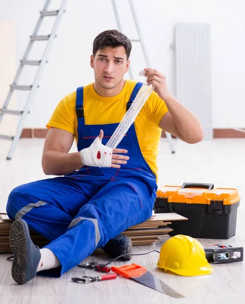 Worker with injured hand at construction site