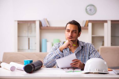 Genç erkek mimar salgın sırasında evden çalışıyor.