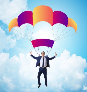 Genç işadamı iş konseptinde paraşütle atlıyor