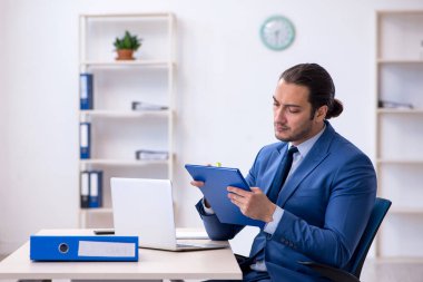 İş yerinde çalışan genç bir erkek.