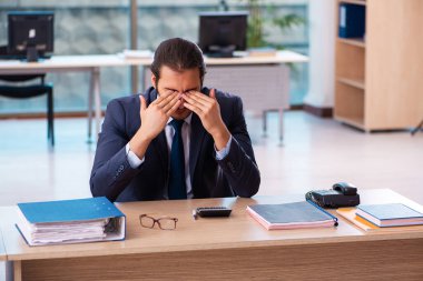 Ofiste çalışan genç bir erkek.