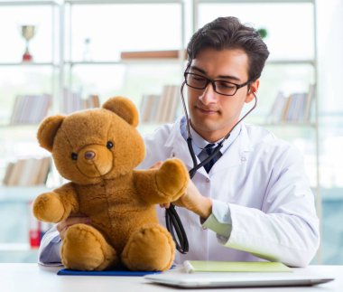 Ofiste oyuncaklı bir çocuk doktoru oturuyor.