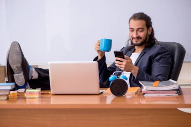 Sınıftaki genç erkek öğretmen.