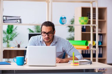 Ofiste çalışan genç bir erkek.