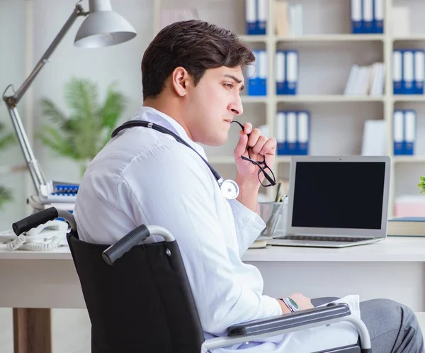 Disabled doctor on wheelchair working in hospital