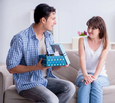 Genç bir kadın doğum günü hediyesi olarak evcil tavşan alıyor.