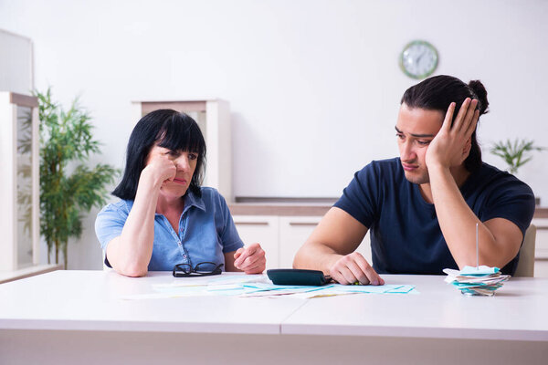 Female pensioner and her young son in budget planning concept