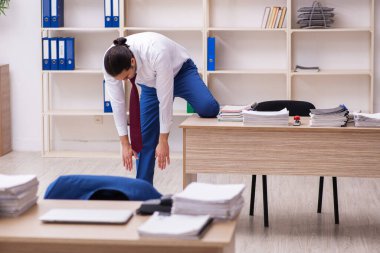 Mola sırasında spor yapan genç erkek çalışanlar.