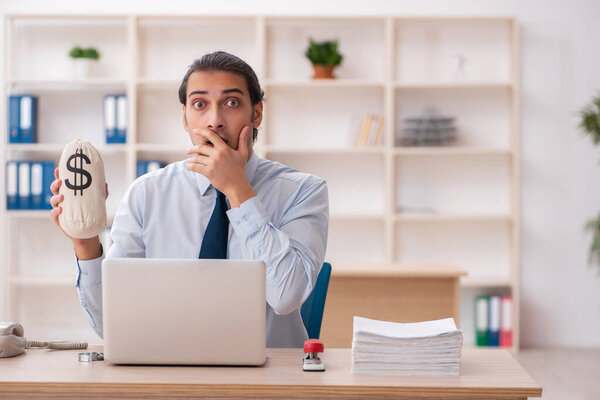 Молодой работник мужского пола в концепции оплаты труда