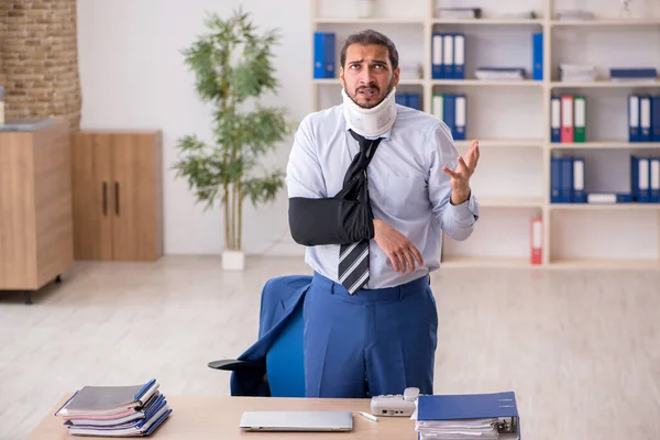 Young man after accident working in the office