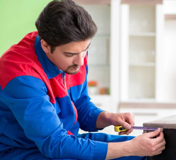 Repair contractor repairing broken furniture at home