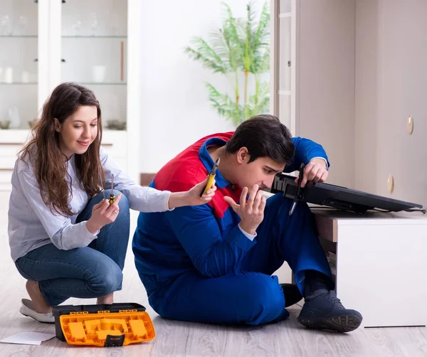 Tv repairman technician repairing tv at home