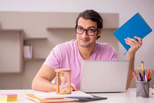 Young male student in time management concept — Stock Photo, Image