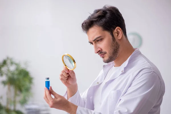 Jovem médico químico masculino segurando frasco para injetáveis — Fotografia de Stock