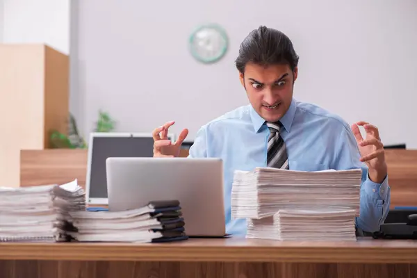 Young male employee unhappy with excessive work — Stock Photo, Image