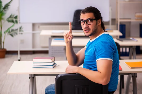 Young male student in the classroom — Stock Photo, Image