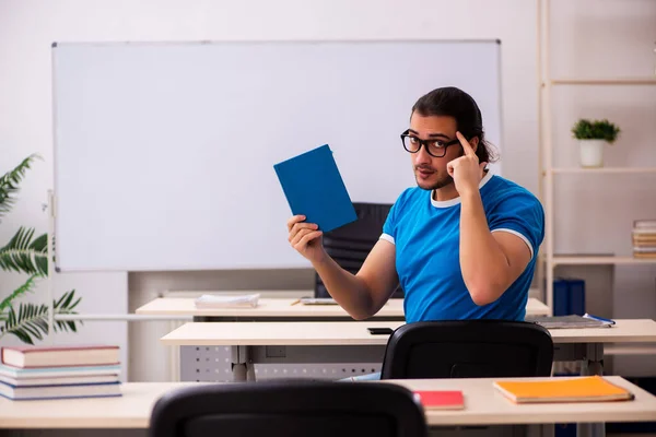 Young male student in the classroom — Stock Photo, Image