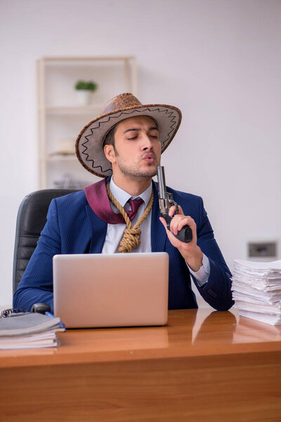 Young cowboy businessman working at workplace