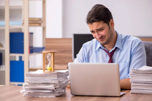 Ung manlig anställd missnöjd med överdrivet arbete på kontoret — Stockfoto