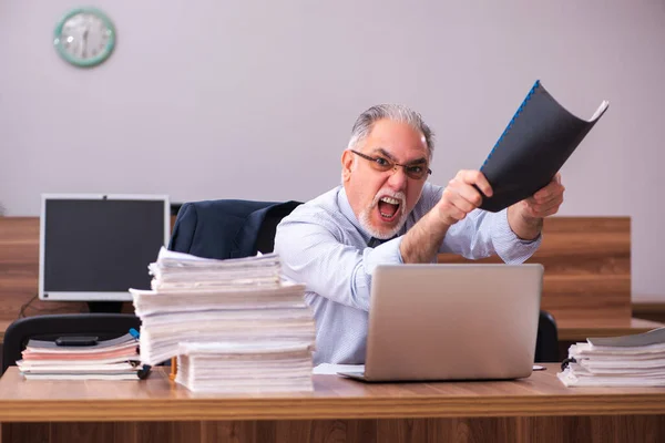 Velho empregado masculino e muito trabalho no escritório — Fotografia de Stock