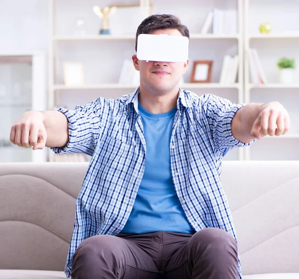 Man with virtual reality glasses playing at home — Stock Photo, Image