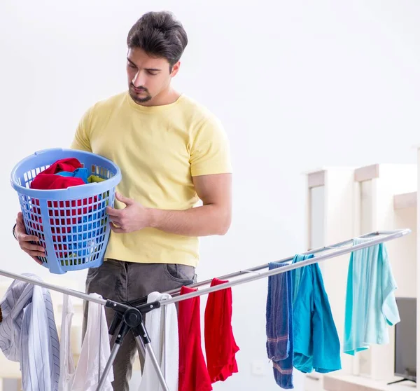 Handsome man husband doing laundering at home — Stock Photo, Image