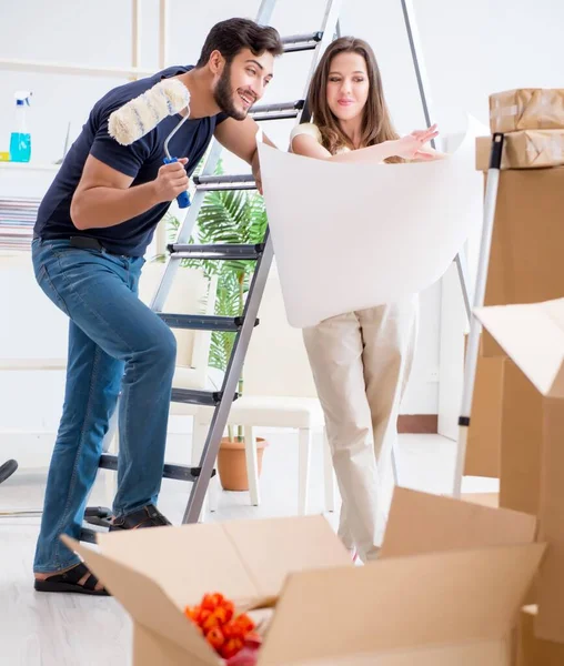Young family unpacking at new house with boxes — Stock Photo, Image