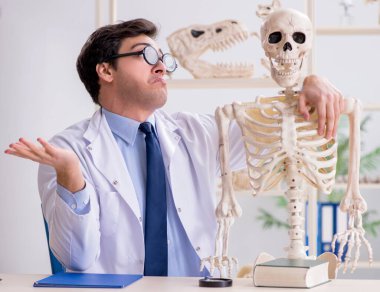 Çılgın profesör insan iskeleti üzerinde çalışıyor.